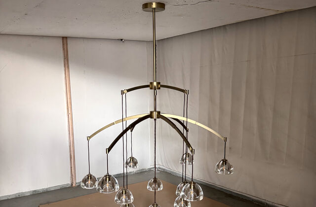 A full multi-arm chandelier hung and powered in the factory test room